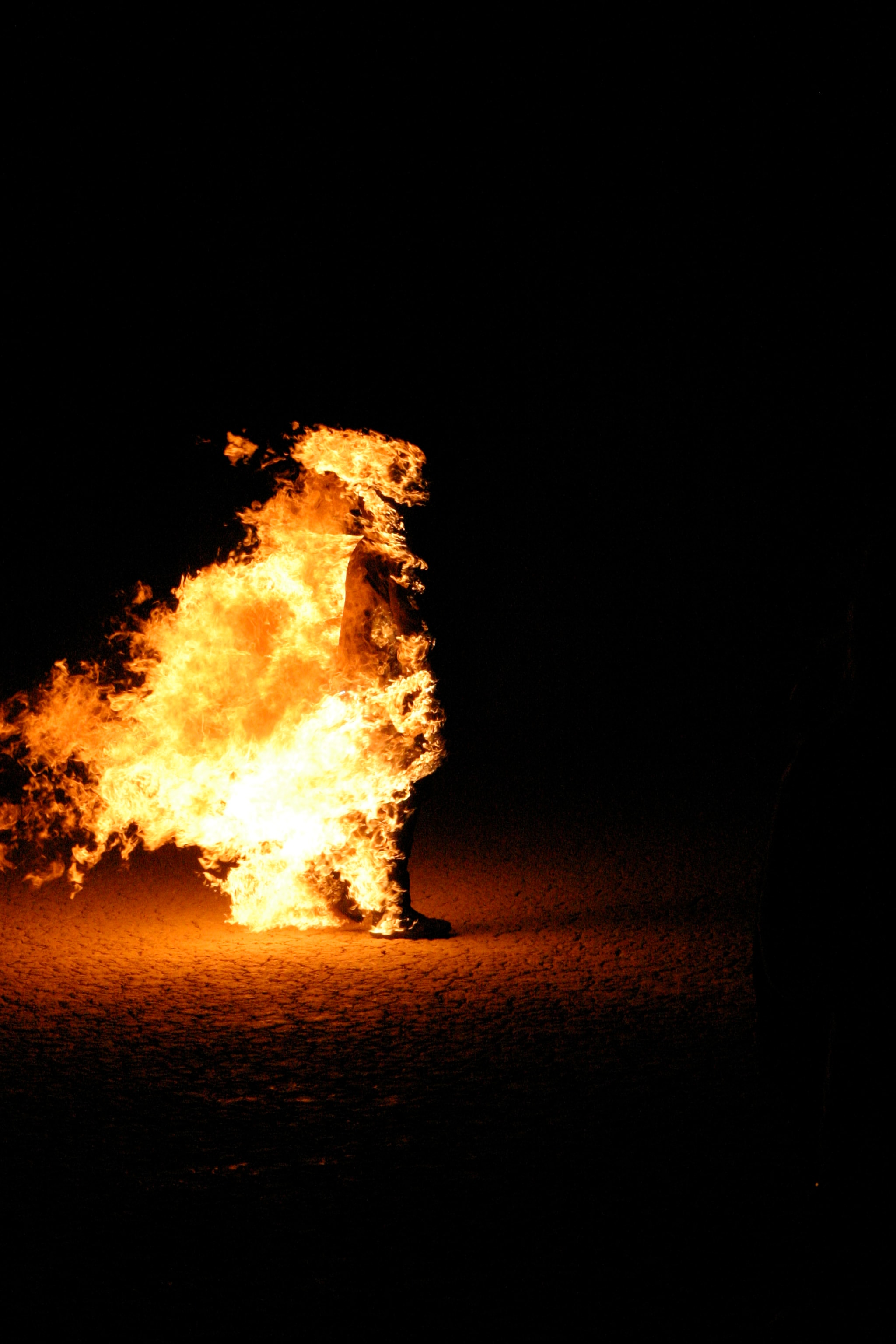 Fire burn stunt performer engulfed in flames at night