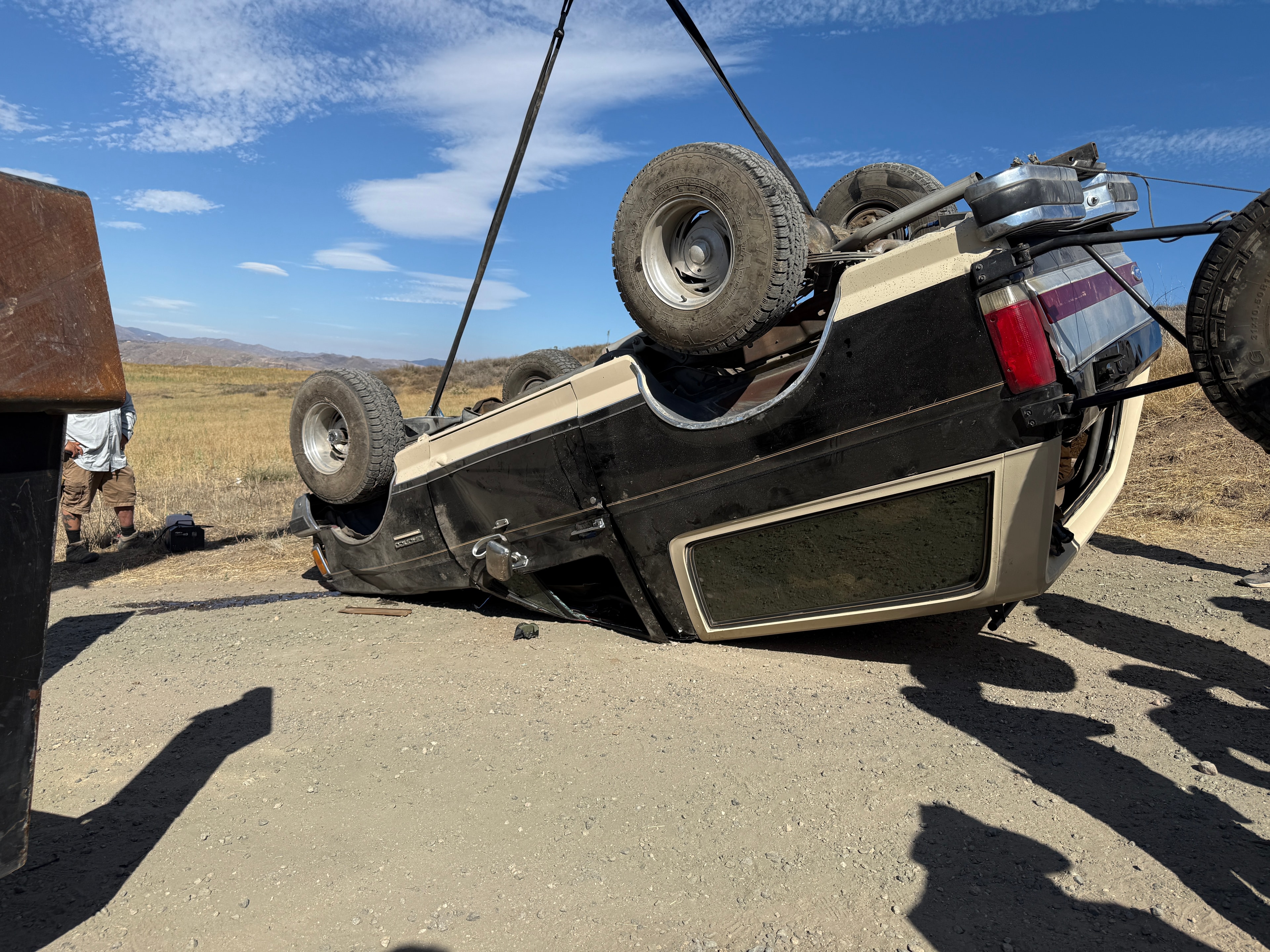 Wrecked vehicle being rigged on production